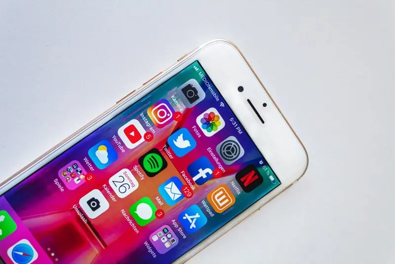 Smartphone with social media icons on screen.