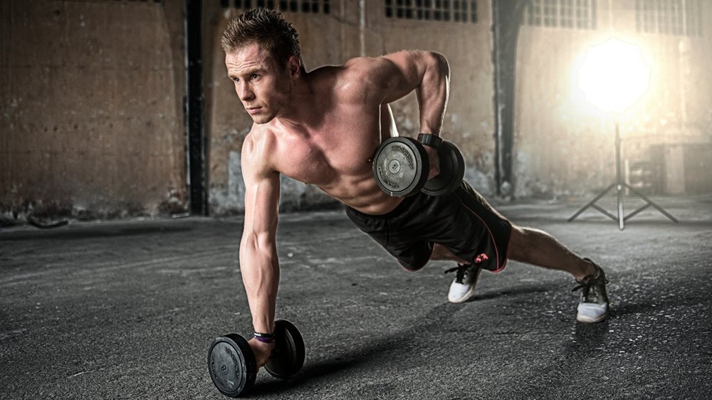 Man doing dumbbell exercises.