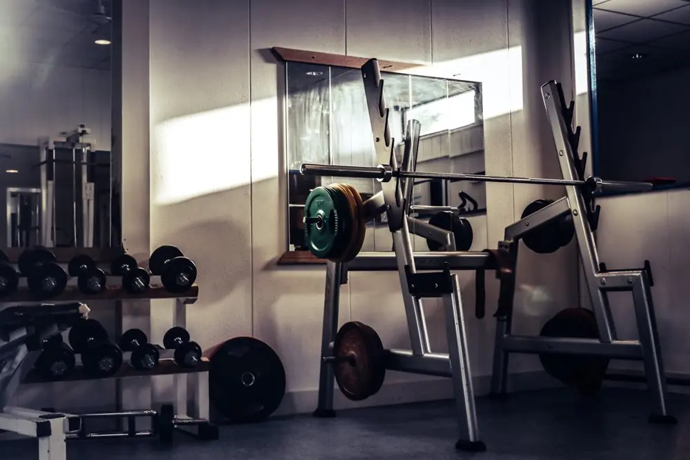 Fitness gym with dumbbells and barbell.