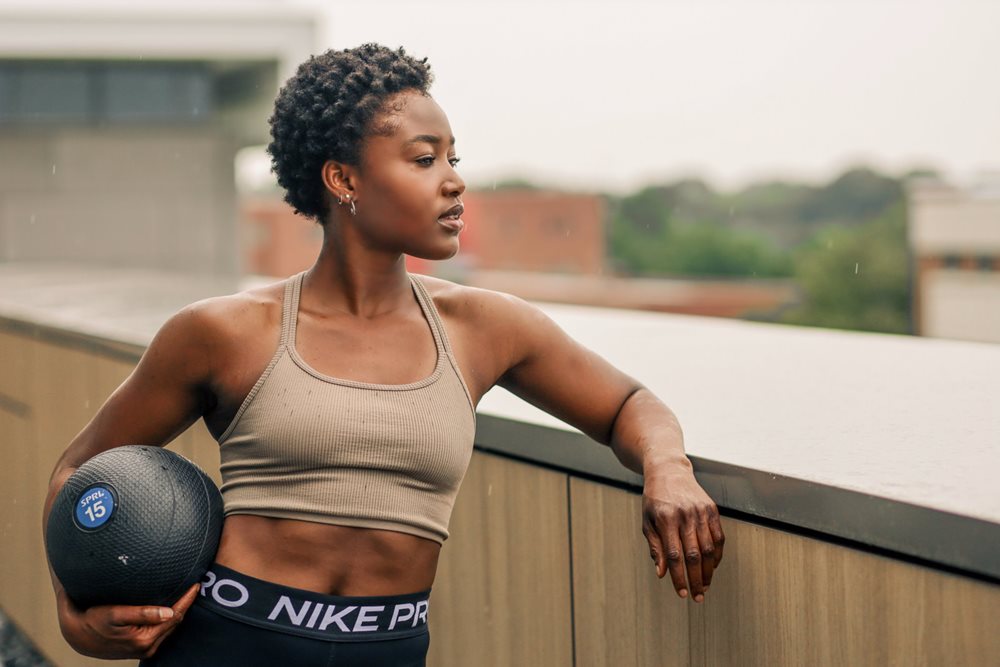 Fit woman holding a medicine ball.