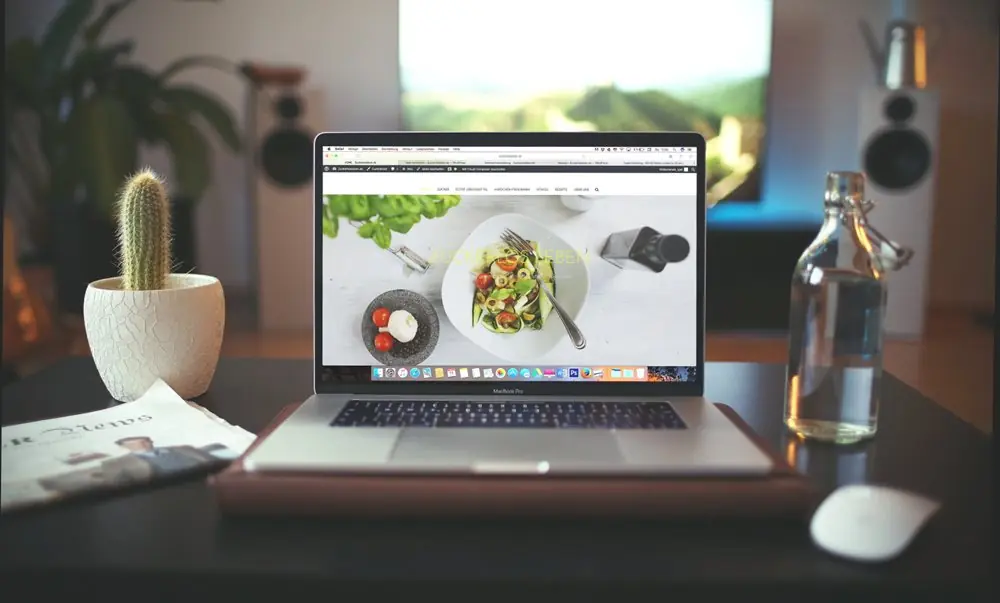 Laptop with graphic design of vegetable plate.