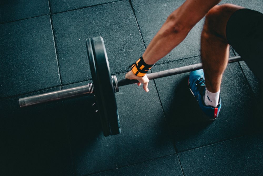 Man grabbing barbell.