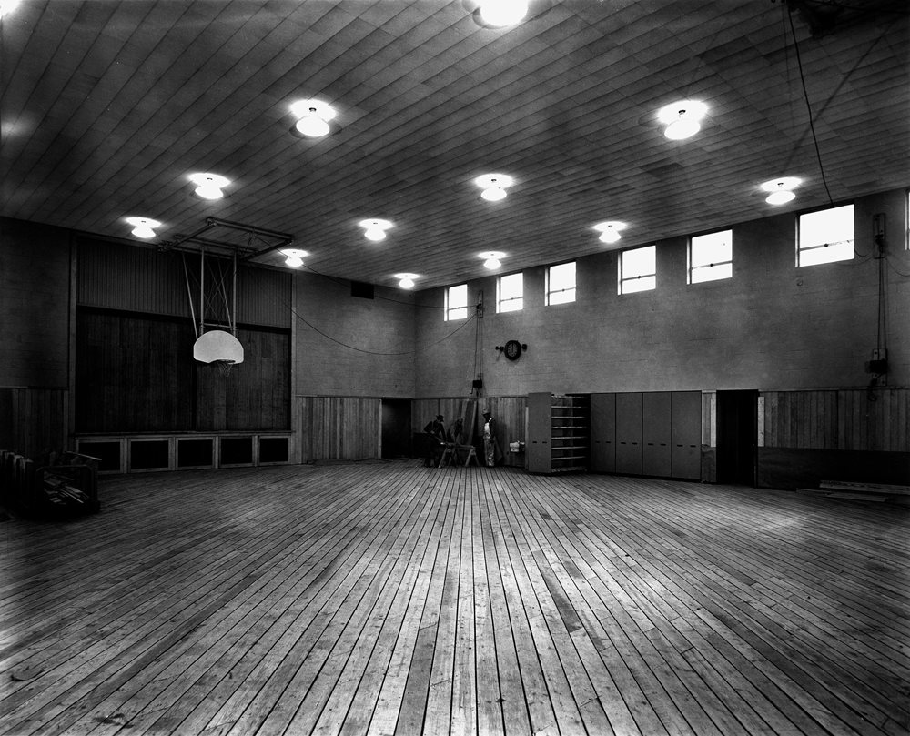 Empty gym with wooden floor.