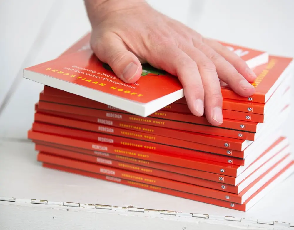 Stack of business success books.