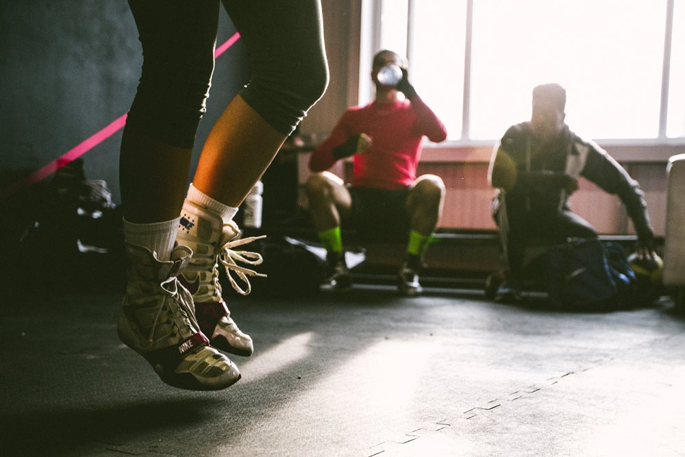 Woman jump roping in gym.