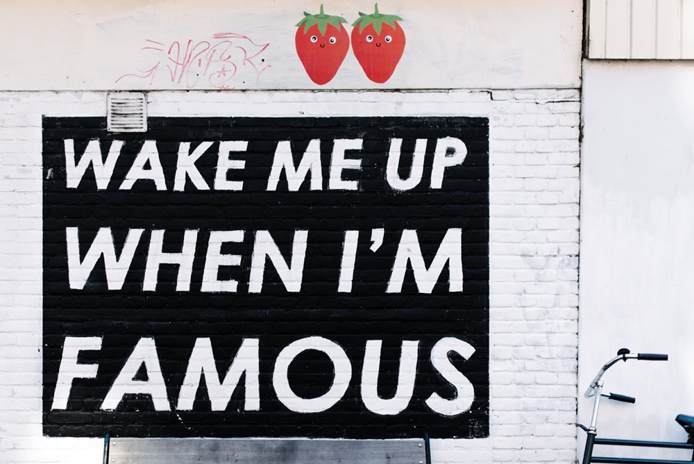 "Wake me up when I'm famous" graffiti on wall.