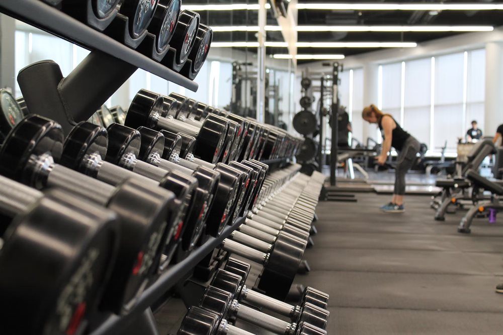 Gym with lots of dumbbells on the rack.