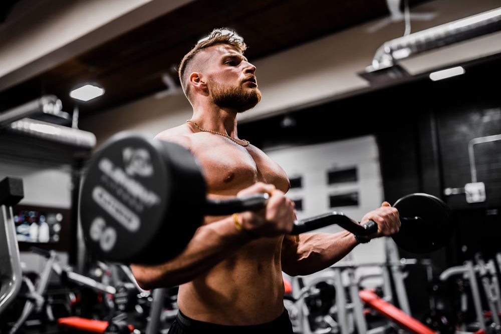 Man curling barbell.